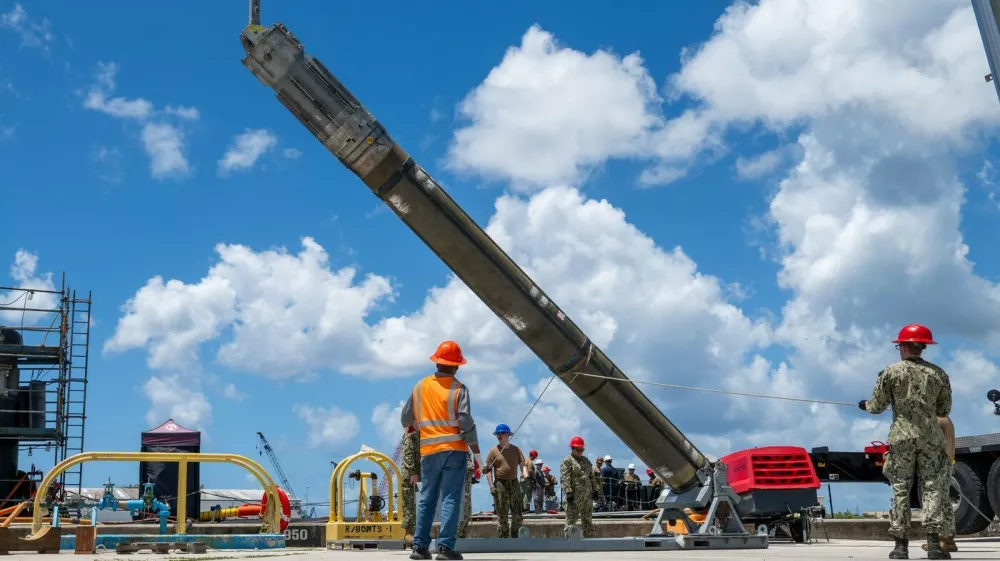 NAVAL BASE GUAM (May 6, 2025) &ndash; Sailors assigned to Navy Munitions Command Pacific, East Asia Division, Unit Guam load UGM-109 Tomahawk missiles onto the Los Angeles-class fast-attack submarine USS Jefferson City (SSN 759), May 6, 2025. Assigned to Commander, Submarine Squadron 15 at Polaris Point, Naval Base Guam, Jefferson City is one of five fast-attack submarines forward-deployed in the Pacific. Renowned for their unparalleled speed, endurance, stealth, and mobility, fast-attack submarines serve as the backbone of the Navy's submarine force, ensuring readiness and agility in safeguarding maritime interests around the world. (U.S. Navy photo by Lt. James Caliva),Image: 1017624832, License: Rights-managed, Restrictions:, Model Release: no
