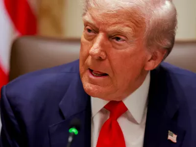U.S. President Donald Trump listens to a reporter's question before his lunch with Argentina's President Javier Milei in the Cabinet Room at the White House in Washington, D.C., U.S., October 14, 2025. REUTERS/Jonathan Ernst
