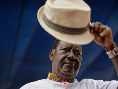 Kenyan opposition leader Raila Odinga lifts his hat to thousands of supporters gathered at a rally in the Shauri Moyo area of Nairobi, Kenya, Wednesday, Oct. 18, 2017. (AP Photo/Ben Curtis)