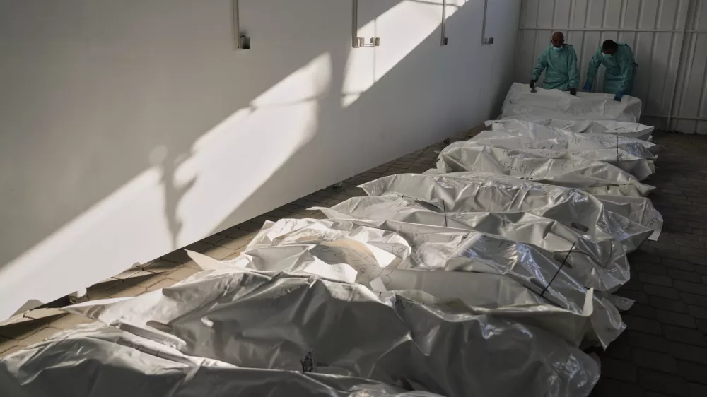 The bodies of deceased Palestinians, held by Israel during the war, lie in plastic bags on the floor of Nasser Hospital in Khan Younis, Gaza, following their release, Wednesday, Oct. 15, 2025. (AP Photo/Jehad Alshrafi)