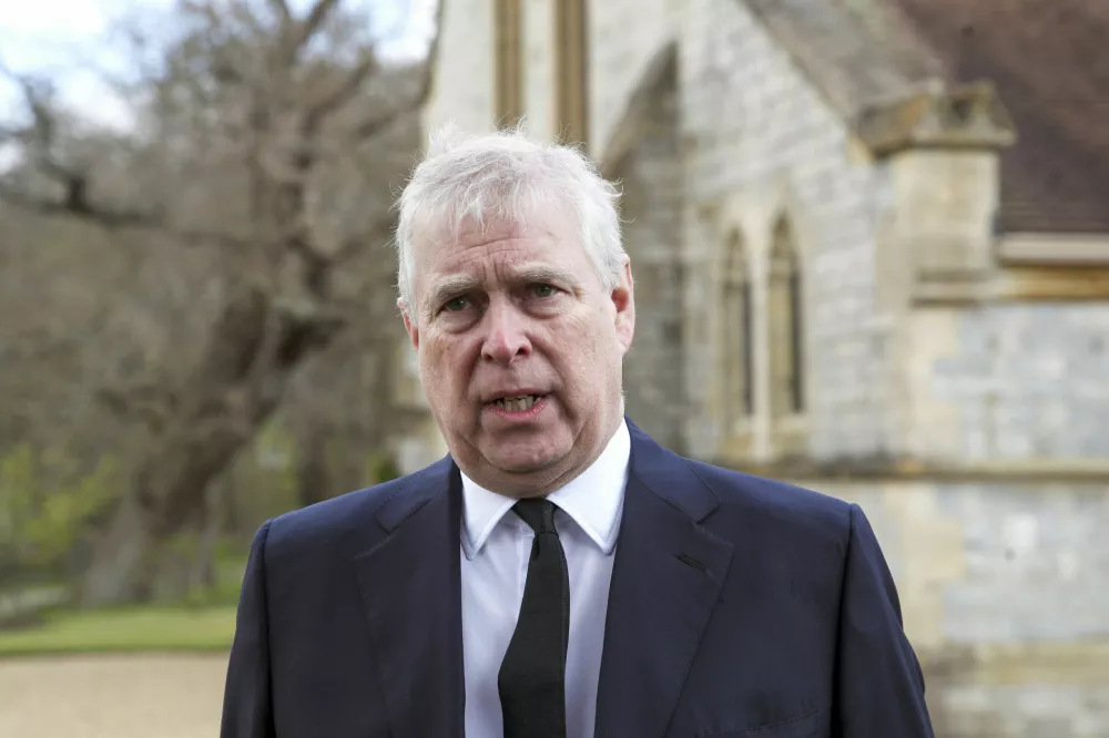 FILE - Britain's Prince Andrew speaks during a television interview at the Royal Chapel of All Saints at Royal Lodge, Windsor, April 11, 2021.  Prince Andrew has agreed to settle a lawsuit filed by Virginia Giuffre, who said she was sexually trafficked to the British royal by the financier Jeffrey Epstein when she was 17. The deal described in a court filing Tuesday, Feb. 15, 2022, in New York avoids a trial that would have brought further embarrassment to the monarchy. (Steve Parsons/Pool Photo via AP, File)
