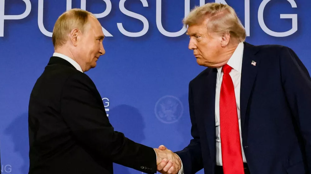 FILE PHOTO: U.S. President Donald Trump and Russian President Vladimir Putin shake hands during a press conference following their meeting to negotiate an end to the war in Ukraine, at Joint Base Elmendorf-Richardson, in Anchorage, Alaska, U.S., August 15, 2025. REUTERS/Kevin Lamarque/File Photo
