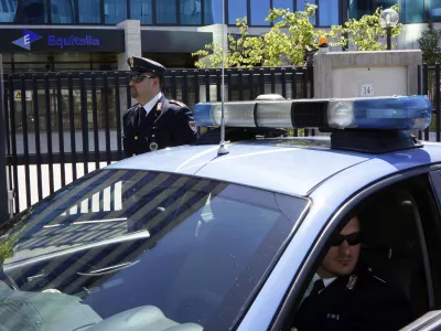 Italian Police officers are seen outside Equitalia tax collection agency headquarters after a letter bomb was intercepted at the offices, in Rome, Friday, May 11, 2012. The letter contained a small amount of explosive, but according to investigators it most probably was unable to explode. In Dec. 2011 the director of another Equitalia office was injured when he opened an envelope addressed to him containing explosives. (AP photo/Domenico Stinellis)