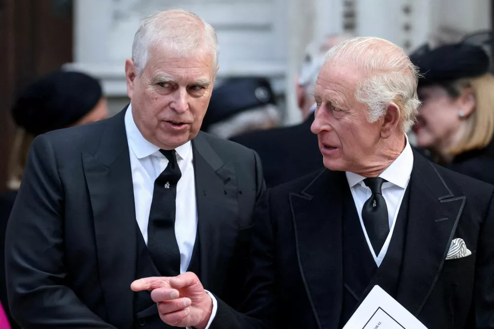 FILE PHOTO: Britain's Prince Andrew speaks with King Charles as they leave Westminster Cathedral at the end of the Requiem Mass, on the day of the funeral of Britain's Katharine, Duchess of Kent, in London, Britain, September 16, 2025. REUTERS/Toby Melville/File Photo