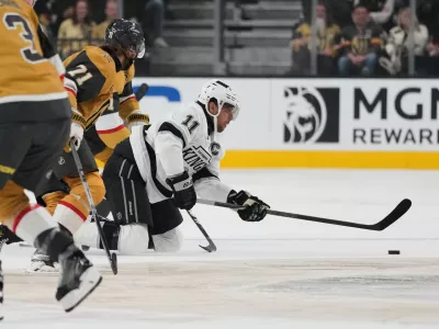 Los Angeles Kings center Anze Kopitar (11) passes against the Vegas Golden Knights during the first period of an NHL hockey game Wednesday, Oct. 8, 2025, in Las Vegas. (AP Photo/John Locher)