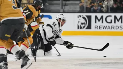 Los Angeles Kings center Anze Kopitar (11) passes against the Vegas Golden Knights during the first period of an NHL hockey game Wednesday, Oct. 8, 2025, in Las Vegas. (AP Photo/John Locher)