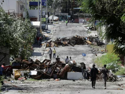 FILE PHOTO: Residents return to the Route de Nazon neighborhood after gang leader Jimmy "Barbeque" Cherizier withdrew his soldiers from several neighborhoods in northeastern Port-au-Prince and urged former residents to return to their homes, in Port-au-Prince, Haiti August 28, 2025. REUTERS/Jean Feguens Regala/File Photo