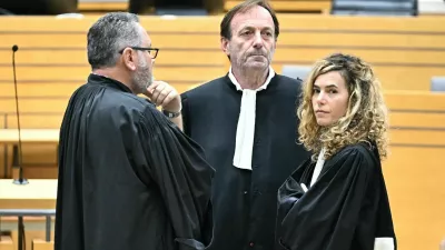17 October 2025, France, Albi: Defendant's lawyers Alexandre Martin (C) and Emmanuelle Franck (R) wait for the opening of their client's trial for the murder of his wife in the courtroom of the Tarn Assize Courthouse. In a trial without a body, witnesses, or confession, a court in France has sentenced a man to 30 years in prison for the murder of his wife. Photo: Lionel Bonaventure/AFP/dpa