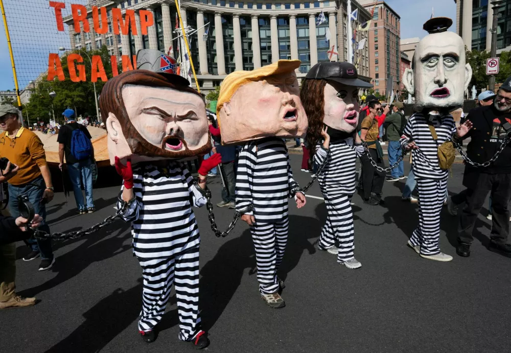 Demonstrators wearing costumes depicting U.S. President Donald Trump, U.S. Vice President JD Vance, U.S. Homeland Security Secretary Kristi Noem, and White House Deputy Chief of Staff Stephen Miller take part in a "No Kings" protest against U.S. President Donald Trump's policies, in Washington, D.C., U.S., October 18, 2025. REUTERS/Leah Millis
