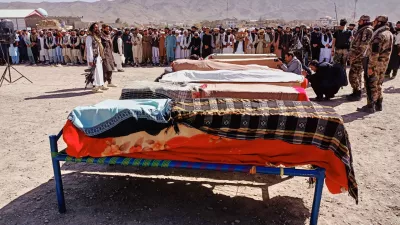The bodies of victims of a Pakistani cross-border airstrike, including three local cricketers, are prepared for their funeral in the village of Khandaro in the Argun district of Afghanistan's eastern Paktika province, Saturday, Oct. 18, 2025. (AP Photo/Shafiqullah Mashaal)