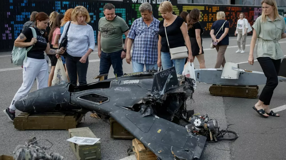 FILE PHOTO: People look at a destroyed Russian combat drone as they visit an exhibition dedicated to Chasiv Yar defence by servicemen of 24th Mechanized brigade named after King Danylo of the Ukrainian Armed Forces, amid Russia's attack on Ukraine, in central Kyiv, Ukraine August 8, 2025. REUTERS/Gleb Garanich/File Photo
