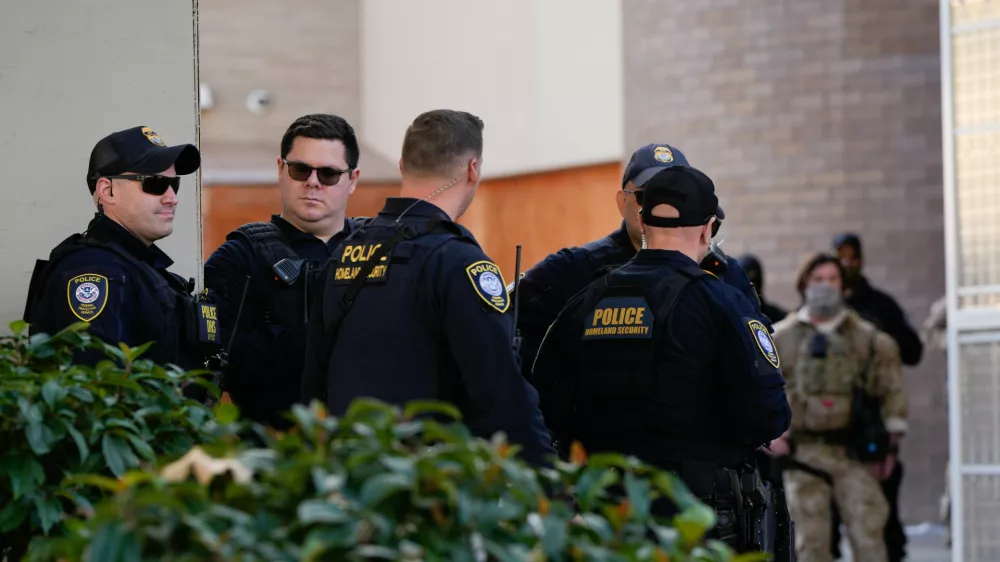 Law enforcement officers are seen outside a United States Immigration and Customs Enforcement (ICE) facility in Portland, Ore., Monday, Oct. 20, 2025. (AP Photo/Jenny Kane)