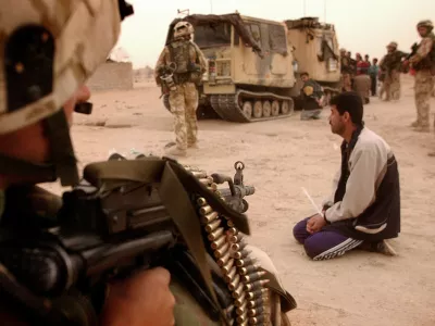 Ira&scaron;ki vojak pred strojnico ameri&scaron;kega komandosa med invazijo leta 2003. / Foto: Profimedia