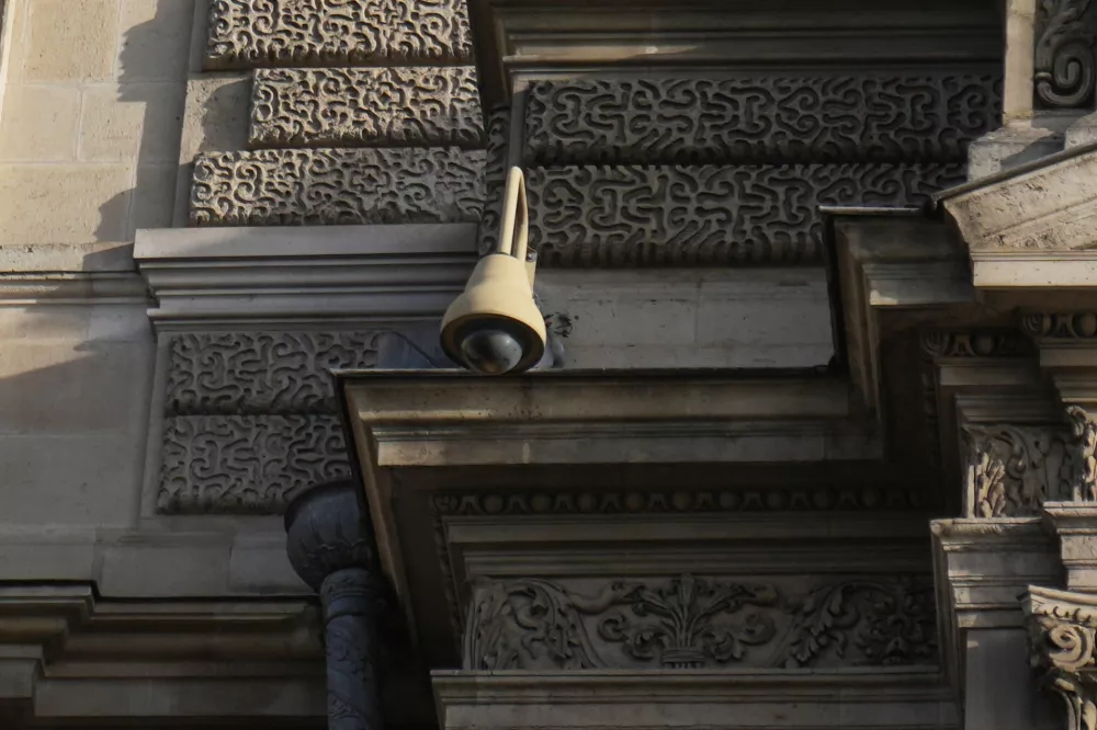 A surveillance camera is seen on a facade of the Louvre museum, three days after historic jewels were stolen in a daring daylight heist, Wednesday, Oct. 22, 2025 in Paris. (AP Photo/Thibault Camus)