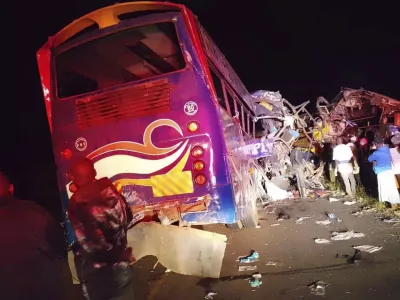 People gather at the scene of a multiple vehicles collision that left at least 63 dead near Gulu, northern Uganda, Wednesday, Oct. 22, 2025. (AP Photo/Uganda Red Cross)