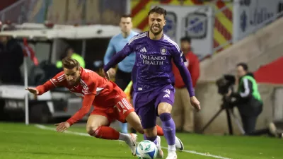 Oct 22, 2025; Bridgeview, Illinois, USA; Chicago Fire FC midfielder Philip Zinckernagel (11) and Orlando City defender David Brekalo (4) battle for control of the ball during the first half at SeatGeek Stadium. Mandatory Credit: Talia Sprague-Imagn Images