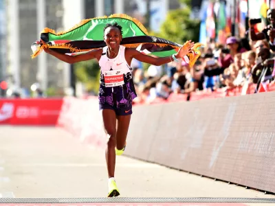 FILE PHOTO: Oct 13, 2024; Chicago, IL, USA; Ruth Chepngetich of Kenya celebrates after finishing first in the women's race, setting a world record at 2:09:56 during the Chicago Marathon at Grant Park. Mandatory Credit: Patrick Gorski-Imagn Images   TPX IMAGES OF THE DAY/File Photo