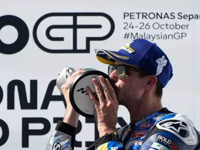 Spain's rider Alex Marquez of the BK8 Gresini Racing MotoGP celebrates on the podium after winning the MotoGP race of the Grand Prix of Malaysia at the Sepang International Circuit in Sepang, Malaysia, Sunday, Oct. 26, 2025. (AP Photo/Aaron Favila)