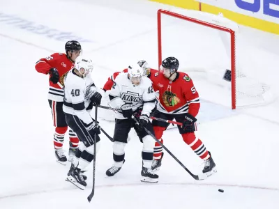 Oct 26, 2025; Chicago, Illinois, USA; Chicago Blackhawks defenseman Artyom Levshunov (55) defends against Los Angeles Kings left wing Trevor Moore (12) during the third period at United Center. Mandatory Credit: Kamil Krzaczynski-Imagn Images