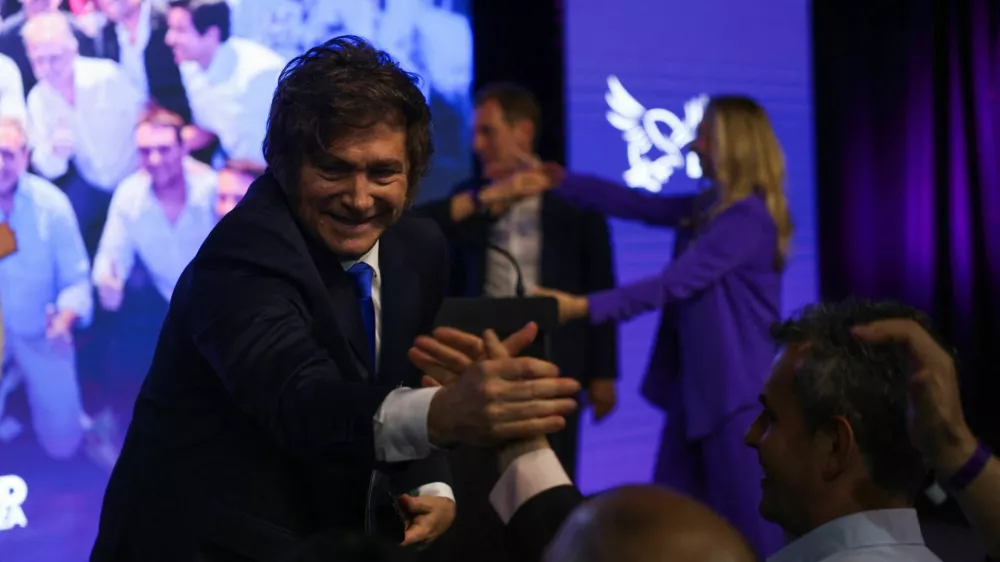 Argentina's President Javier Milei reacts as he greets people after the La Libertad Avanza party won the midterm election, which is seen as crucial for Milei's administration after U.S. President Donald Trump warned that future support for Argentina would depend on Milei's party performing well in the vote, in Buenos Aires, Argentina, October 26, 2025. REUTERS/Cristina Sille