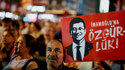 FILE PHOTO: A man holds up a sign featuring an image of Istanbul Mayor Ekrem Imamoglu during a rally to protest against a recent court ruling that ousted the main opposition Republican People's Party's (CHP) Istanbul provincial leadership, in Istanbul, Turkey, September 10, 2025. REUTERS/Umit Bektas/File Photo