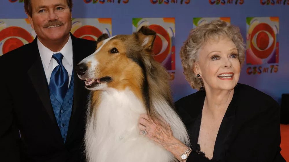 FILE - June Lockhart, right, who played the character of Ruth Martin, mother of Timmy Martin, played by Jon Provost, left, during the classic series "Lassie," poses for a photograph with Lassie, 9th generation, during arrivals at CBS's 75th anniversary celebration Sunday, Nov. 2, 2003, in New York. (AP Photo/Louis Lanzano, File)