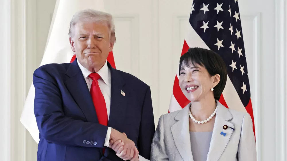 President Donald Trump, left, and Japanese Prime Minister Sanae Takaichi shake hands before their summit talk at Akasaka Palace in Tokyo, Tuesday, Oct. 28, 2025. (Kyodo News via AP)
