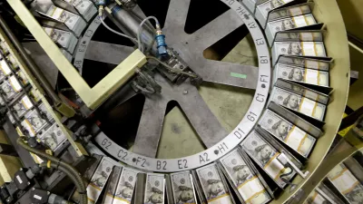 FILE - In this Sept. 24, 2013 file photo, freshly cut stacks of 0 bills make their way down the line at the Bureau of Engraving and Printing Western Currency Facility in Fort Worth, Texas. (AP Photo/LM Otero, File)