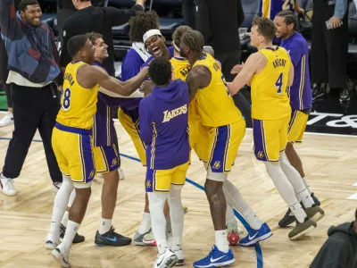 Oct 29, 2025; Minneapolis, Minnesota, USA; Los Angeles Lakers guard Austin Reaves (15) celebrates with forward Jarred Vanderbilt (2) and center Deandre Ayton (5) after making a buzzer beater shot against the Minnesota Timberwolves at Target Center. Mandatory Credit: Jesse Johnson-Imagn Images