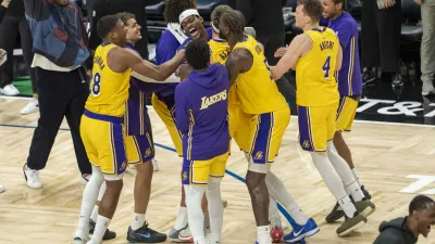 Oct 29, 2025; Minneapolis, Minnesota, USA; Los Angeles Lakers guard Austin Reaves (15) celebrates with forward Jarred Vanderbilt (2) and center Deandre Ayton (5) after making a buzzer beater shot against the Minnesota Timberwolves at Target Center. Mandatory Credit: Jesse Johnson-Imagn Images