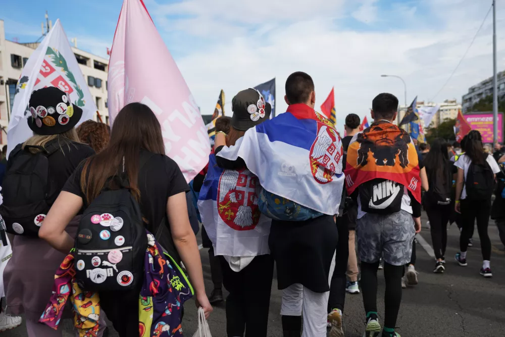 People gather, among them students, to walk on the street towards the northern city of Novi Sad, for a huge rally on Nov. 1 marking the first anniversary of a train station disaster that killed 16 people, in Belgrade, Serbia, Thursday, Oct. 30, 2025. (AP Photo/Darko Vojinovic)