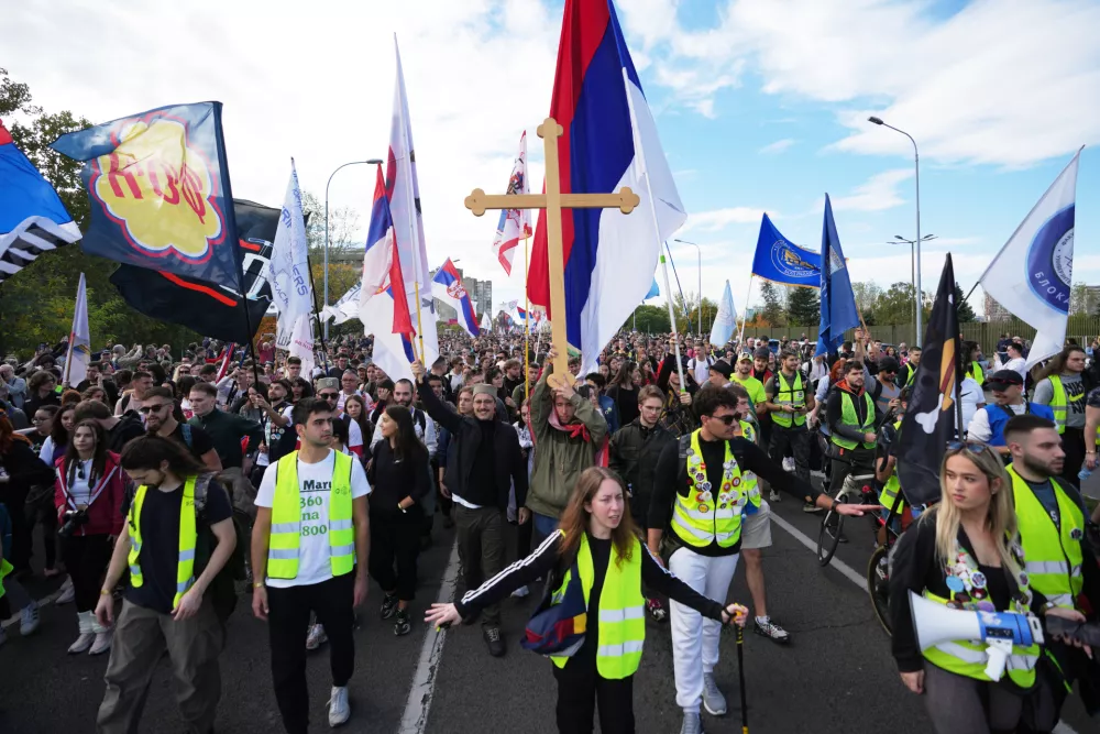 People gather, among them students, to walk on the street towards the northern city of Novi Sad, for a huge rally on Nov. 1 marking the first anniversary of a train station disaster that killed 16 people, in Belgrade, Serbia, Thursday, Oct. 30, 2025. (AP Photo/Darko Vojinovic)