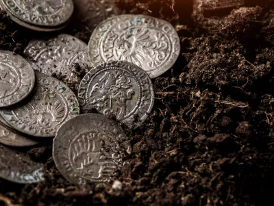 Closeup view of medieval European silver coins.Zygmunt III Waza.Ancient silver coins.Numismatics.silver coins covered in dirt.Antikvariat.