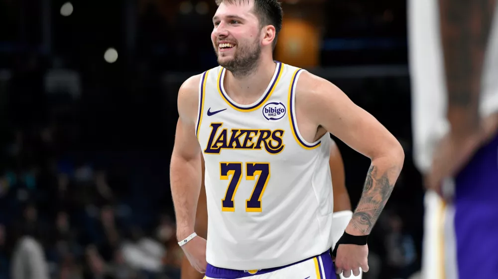 Los Angeles Lakers guard Luka Doncic (77) reacts in the second half of an NBA Cup basketball game against the Memphis Grizzlies Friday, Oct. 31, 2025, in Memphis, Tenn. (AP Photo/Brandon Dill)