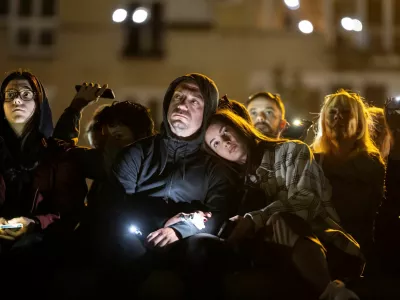People flash mobile phone lights during a 16 minutes of silence, on the first anniversary of the fatal November 2024 Novi Sad railway station canopy collapse, which killed 16 people, triggering nationwide accusations of widespread corruption and negligence, in Novi Sad, Serbia, November 1, 2025. REUTERS/Marko Djurica