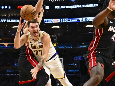 Nov 2, 2025; Los Angeles, California, USA; Los Angeles Lakers guard Luka Doncic (77) passes the ball against Miami Heat guard Pelle Larsson (9) during the second half at Crypto.com Arena. Mandatory Credit: Jonathan Hui-Imagn Images
