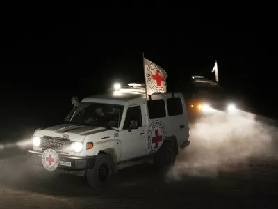 Red Cross vehicles carrying the bodies of three people believed to be deceased hostages handed over by Hamas make their way toward the border crossing with Israel, to be transferred to Israeli authorities, in Deir al-Balah, central Gaza Strip, Sunday, Nov. 2, 2025. (AP Photo/Jehad Alshrafi)