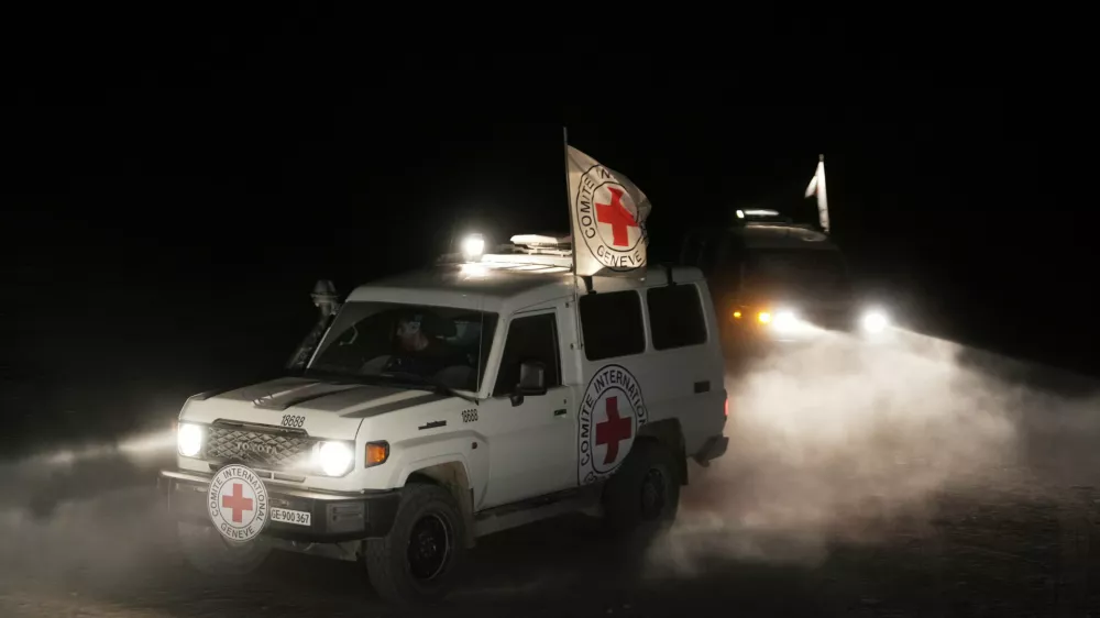 Red Cross vehicles carrying the bodies of three people believed to be deceased hostages handed over by Hamas make their way toward the border crossing with Israel, to be transferred to Israeli authorities, in Deir al-Balah, central Gaza Strip, Sunday, Nov. 2, 2025. (AP Photo/Jehad Alshrafi)