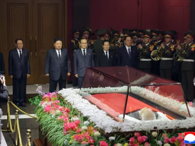 In this photo provided by the North Korean government, its leader Kim Jong Un, back third left, offers his condolences in front of the coffin of Kim Yong Nam at an undisclosed location in North Korea, early Tuesday, Nov. 4, 2025. Independent journalists were not given access to cover the event depicted in this image distributed by the North Korean government. The content of this image is as provided and cannot be independently verified. Korean language watermark on image as provided by source reads: "KCNA" which is the abbreviation for Korean Central News Agency. (Korean Central News Agency/Korea News Service via AP)