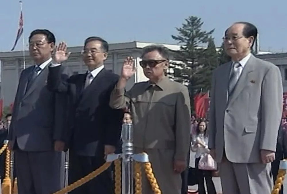 In this image from a footage shot by APTN, Chinese Premier Wen Jiabao, second from left, and North Korean leader Kim Jong Il, second from right, wave to well wishers upon Wen's arrival in Pyongyang, North Korea, Sunday, Oct. 4, 2009. Wen arrived Sunday here on a highly anticipated state visit amid signs the North may be willing to restart dialogue over its nuclear programs following months of resistance. Accompanied Wen and Kim are chairman of the Standing Committee of the North Korean Supreme People's Assembly, Kim Young Nam, right, and North Korean premier Kim Yong Il, left. (AP Photo/APTN)