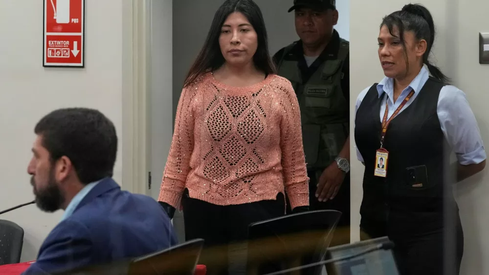 Peruvian former Prime Minister Betssy Chavez arrives for her trial on charges of rebellion and conspiracy against the state at a police base on the outskirts of Lima, Peru, Tuesday, March 18, 2025. (AP Photo/Martin Mejia)