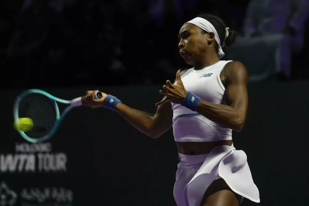 Coco Gauff of the United States plays a shot against Jasmine Paolini of Italy during their women's singles match at the WTA tennis finals in Riyadh, Saudi Arabia, Tuesday, Nov. 4, 2025. (AP Photo/ Fatima Shbair)
