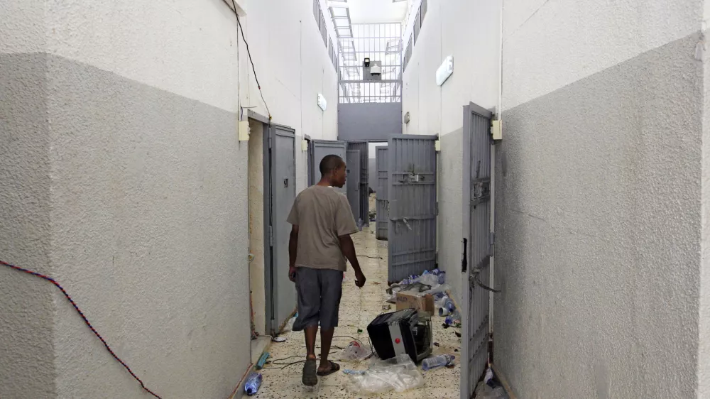 A Libyan walks inside the Abu Salim prison in Tripoli, LIbya, Friday, Aug. 26, 2011, one Libya's most notorious prisons and the scene of a 1996 massacre of prisoners. (AP Photo/Sergey Ponomarev)