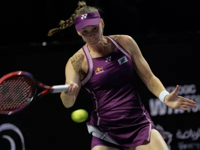 Elena Rybakina of Kazakhstan returns a shot from Ekaterina Alexandrova of Russia during their women's singles match at the WTA tennis finals in Riyadh, Saudi Arabia, Wednesday, Nov. 5, 2025. (AP Photo/Fatima Shbair)
