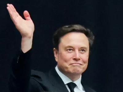 FILE PHOTO: Tesla CEO Elon Musk attends a memorial service for slain conservative commentator Charlie Kirk at State Farm Stadium, in Glendale, Arizona, U.S., September 21, 2025. REUTERS/Daniel Cole/File Photo