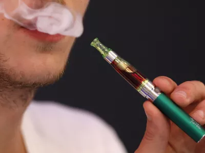 Martin Borne, co-founder of electronic cigarette retailer "Demain J'arrete", demonstrates the use of an electronic cigarette in his shop in Paris October 8, 2013. The European Parliament voted on Tuesday to water down proposed tobacco legislation, rejecting an immediate ban on menthol cigarettes and scaling down the size of health warnings on packets following intense lobbying by tobacco companies. The parliament also said manufacturers should be free to sell smokeless e-cigarettes, which deliver nicotine electronically and are a rapidly growing market, as a consumer product when not being marketed as an aide to help people quit smoking. REUTERS/Charles Platiau (FRANCE - Tags: SOCIETY HEALTH BUSINESS POLITICS)