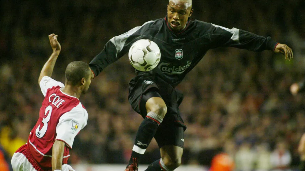 Arsenal's Ashley Cole, left, challenges Liverpool's El-Hadji Diouf during their FA Premier League soccer match at Arsenal's Highbury ground in London Sunday, Dec. 29, 2002. (AP Photo/Alastair Grant)