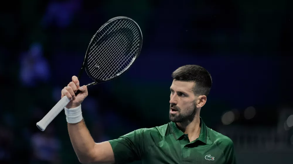 Novak Djokovic of Serbia celebrates after winning a set against Alejandro Tabilo of Chile during the ATP tournament round of 16 tennis match, in Athens, Greece, Tuesday, Nov. 4, 2025. (AP Photo/Petros Giannakouris)