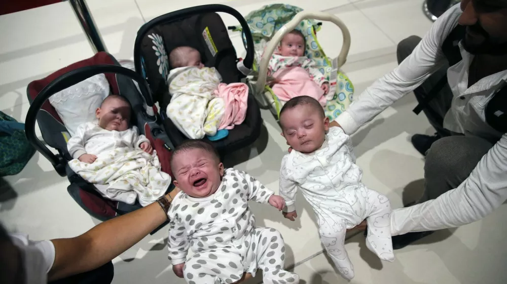 ISTANBUL, TURKEY - JULY 27: Huseyin Huyluoglu and his wife Merve Ozer Huyluoglu with their children including quintuplets arrive at Istanbul Airport in Istanbul, Turkey on July 27, 2020. Huyluoglu family was brought to Turkey by Ministry of Family, Labour and Social Services as they had hard times due to coronavirus (Covid-19) pandemic in Saudi Arabia. Isa Terli / Anadolu Agency,Image: 548084784, License: Rights-managed, Restrictions:, Model Release: no