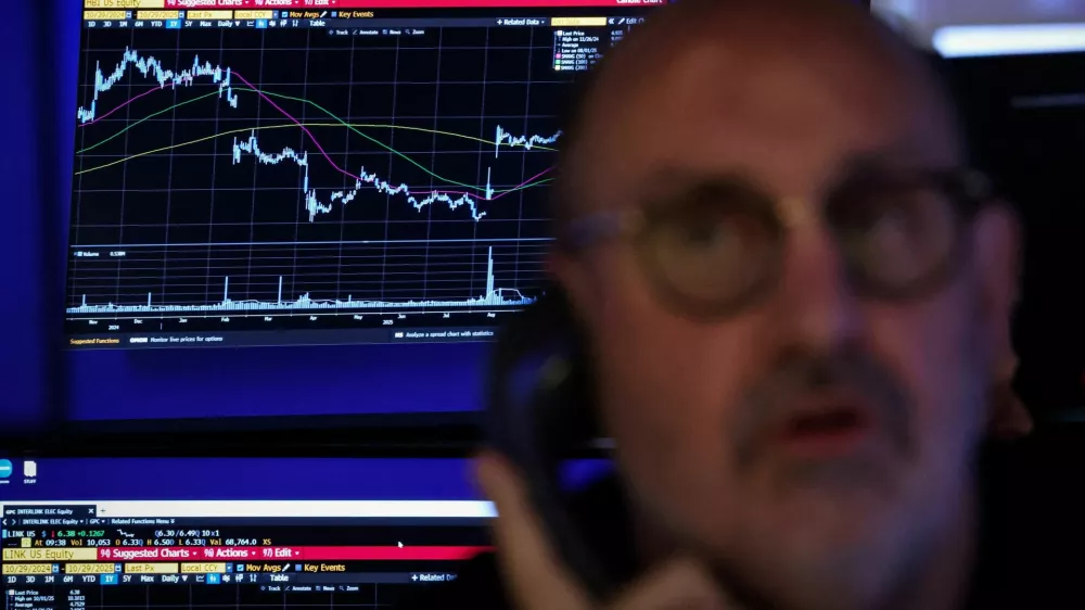 FILE PHOTO: A trader works on the floor at the New York Stock Exchange (NYSE) in New York City, U.S., October 29, 2025. REUTERS/Brendan McDermid/File Photo